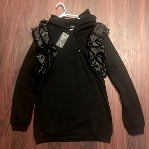 Miss Ord black sweater dress with ruffles.